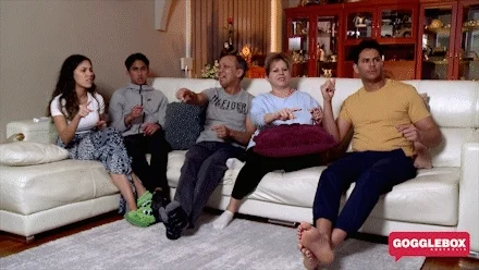 family on a couch pointing in the same direction